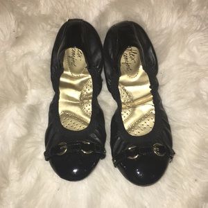 black flats with golden buckle